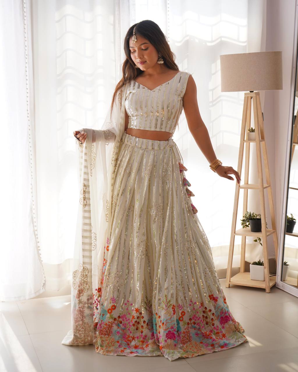 Woman in a traditional outfit with floral details indoors
