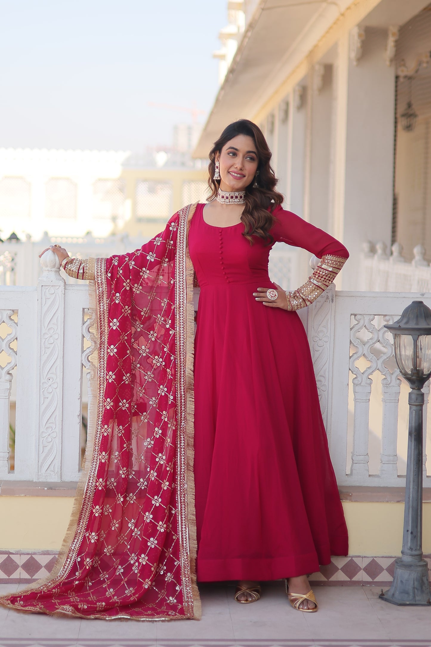 Woman in a red traditional outfit standing on a staircase