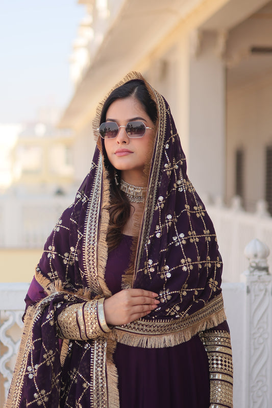 Woman in a traditional embroidered outfit with sunglasses, lying on a white surface.