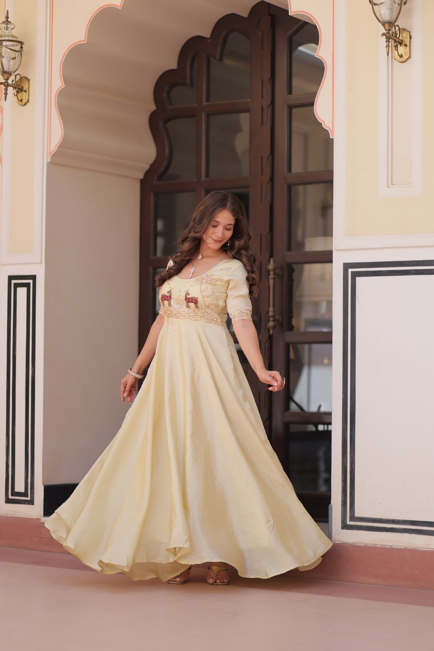 Woman in a white dress standing in front of a mirror, reflecting on her reflection.