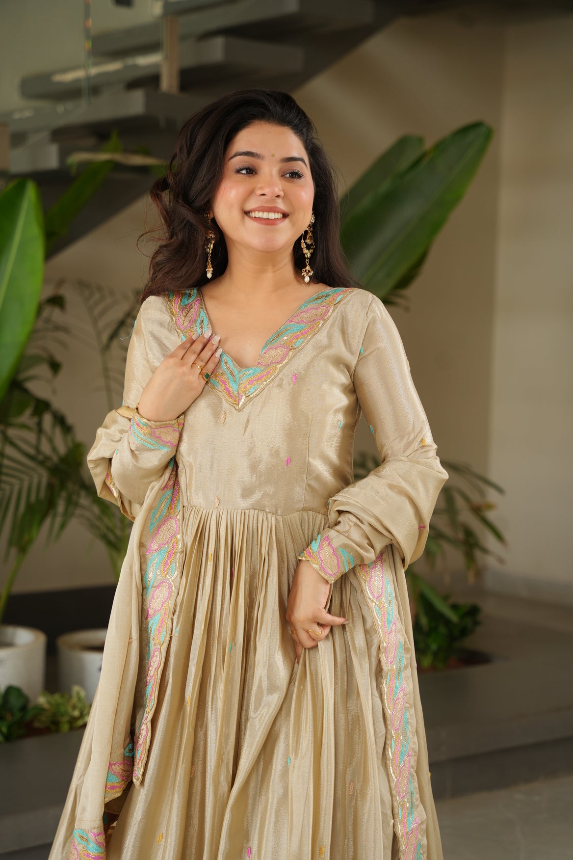 Woman in a traditional outfit with floral patterns indoors