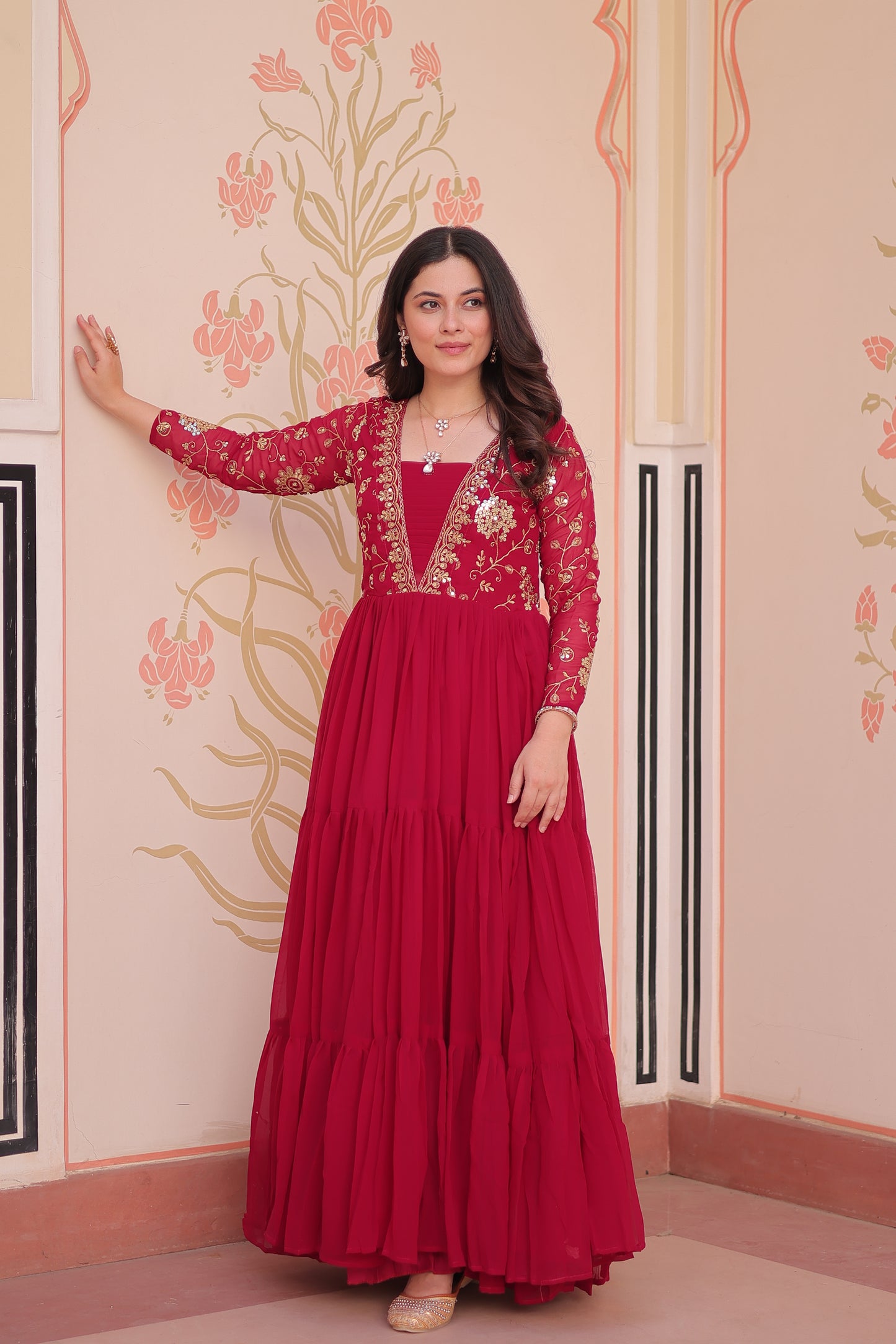 Woman in a red dress standing on a decorative floor