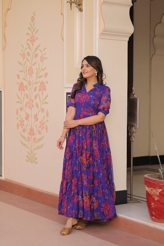 Woman wearing a blue floral dress standing in front of a mirror.