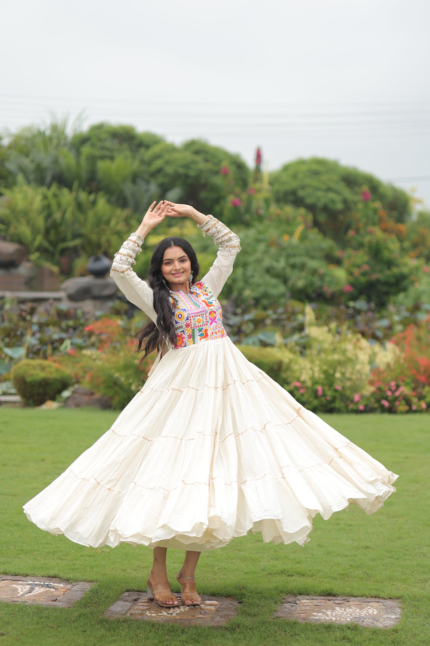 Woman in a white dress standing on grass with a blurred background